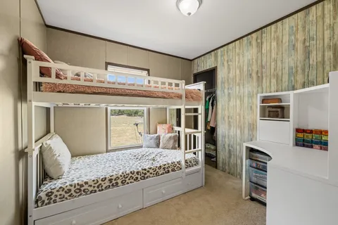 a bedroom with a large bed and a large window