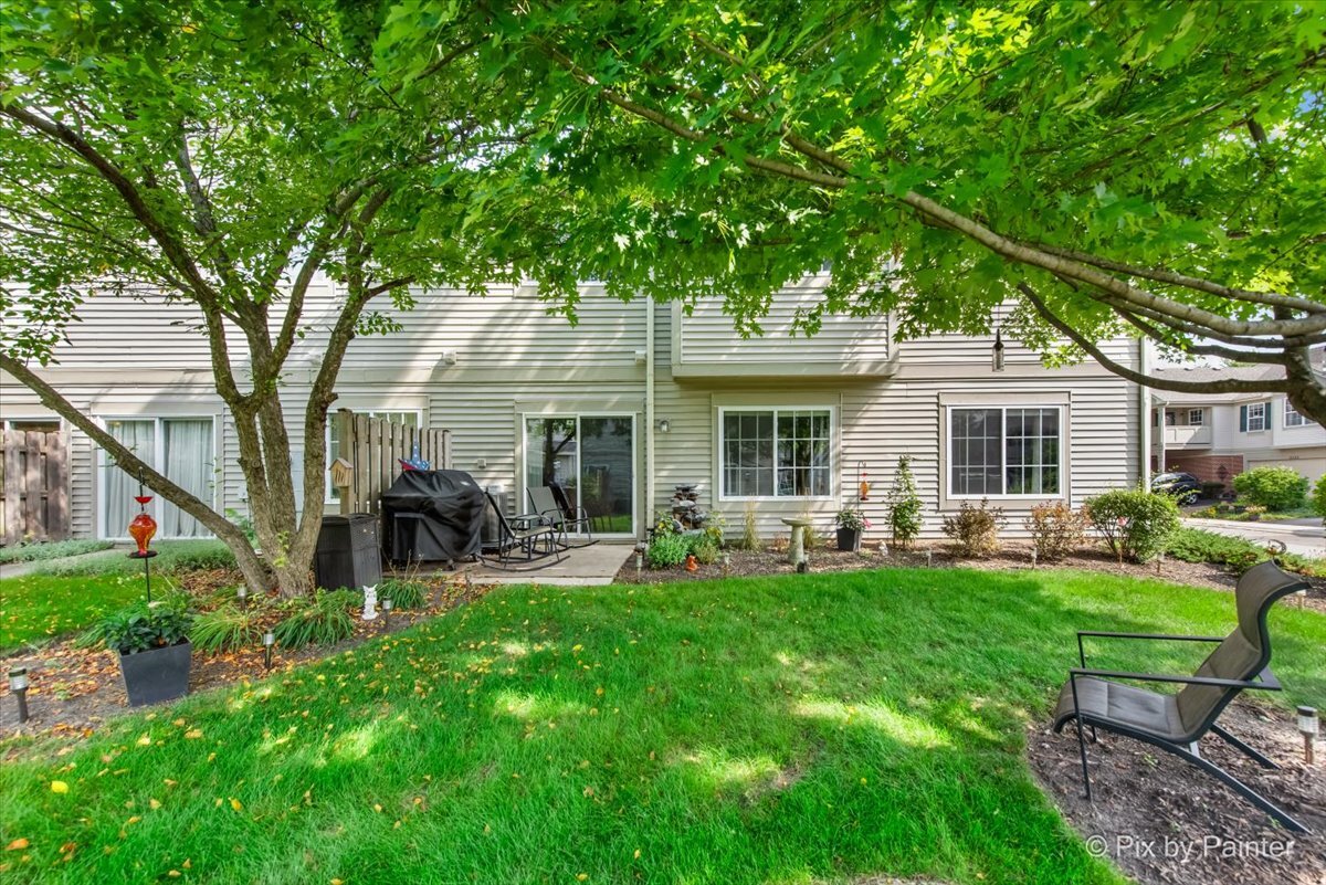 2138 Vanderbilt Drive Geneva, IL 60134 - Photo 16 of 18 a front view of a house with backyard garden and patio