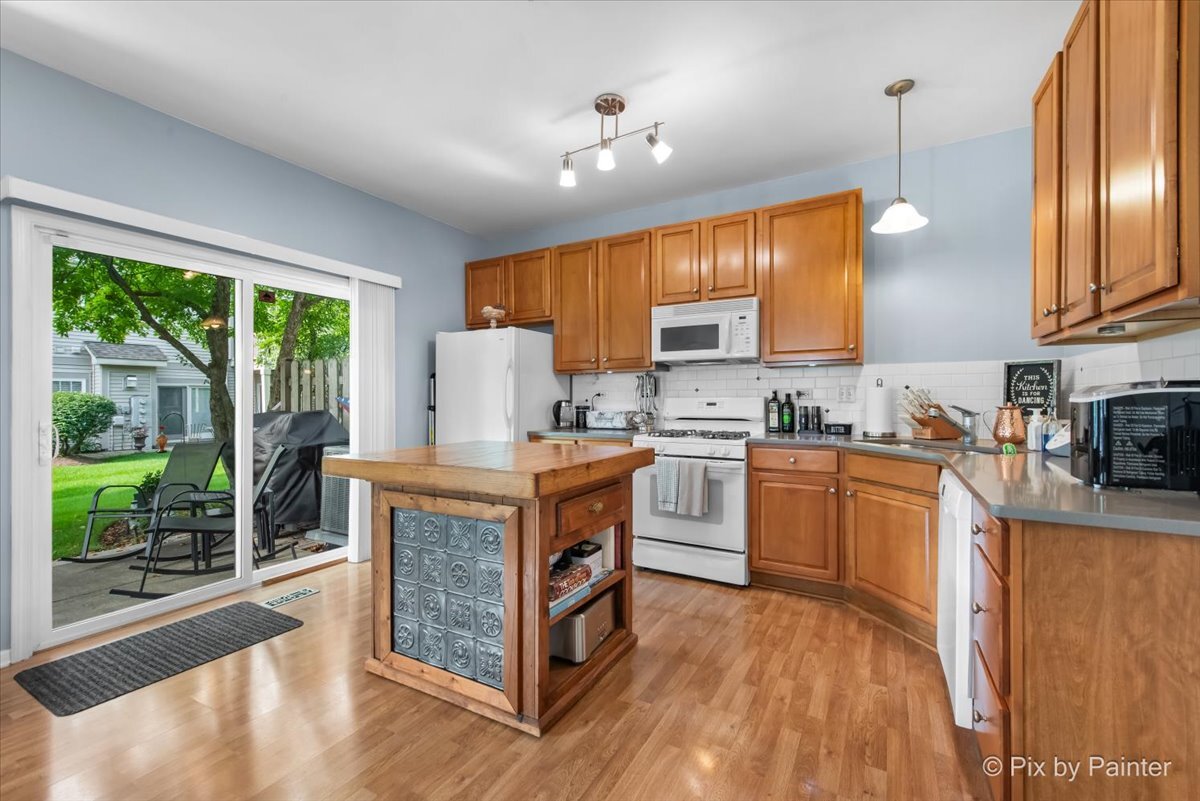 2138 Vanderbilt Drive Geneva, IL 60134 - Photo 5 of 18 a kitchen with a stove a sink and a refrigerator
