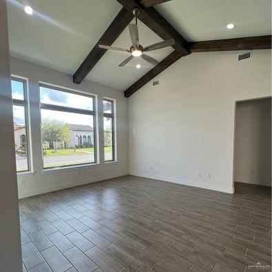 804 Grayson Avenue McAllen, TX 78504 - Photo 2 of 30 an empty room with wooden floor and windows