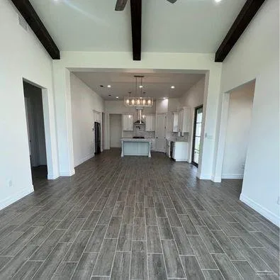 a view of a kitchen with a sink and refrigerator