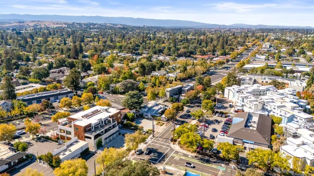 an aerial view of residential building with green space