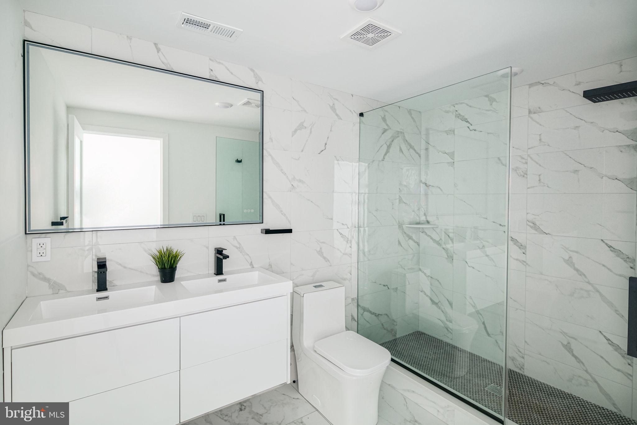 2607 East Boston Street, Unit 1 Philadelphia, PA 19125 - Photo 11 of 25 a bathroom with a sink a toilet and shower