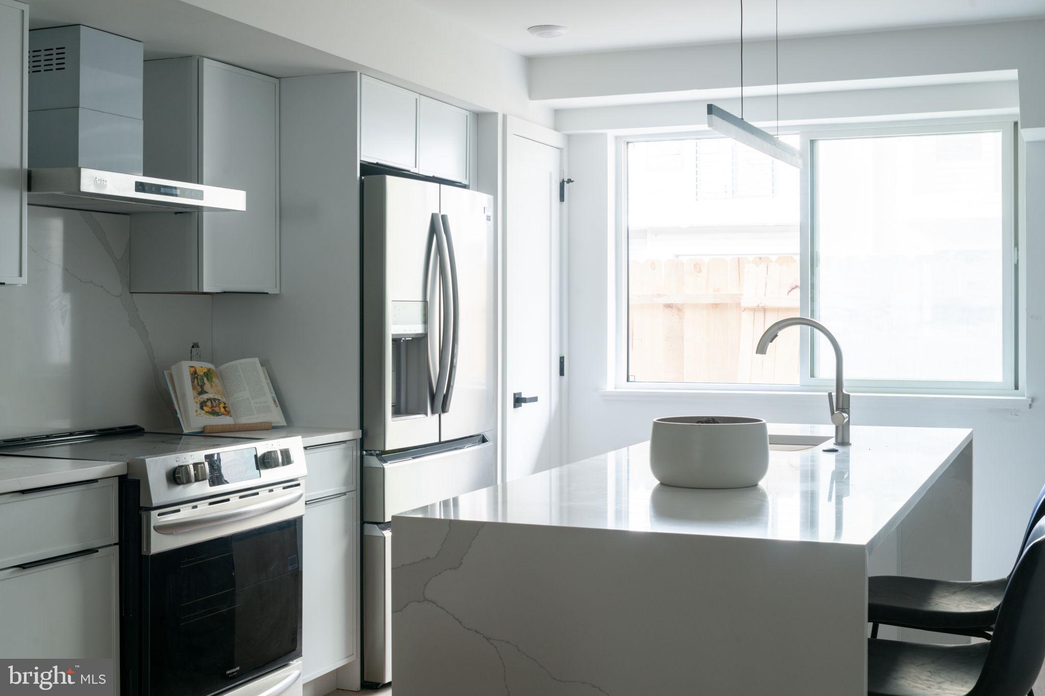 2607 East Boston Street, Unit 1 Philadelphia, PA 19125 - Photo 17 of 25 a kitchen with stainless steel appliances a sink a stove and a refrigerator