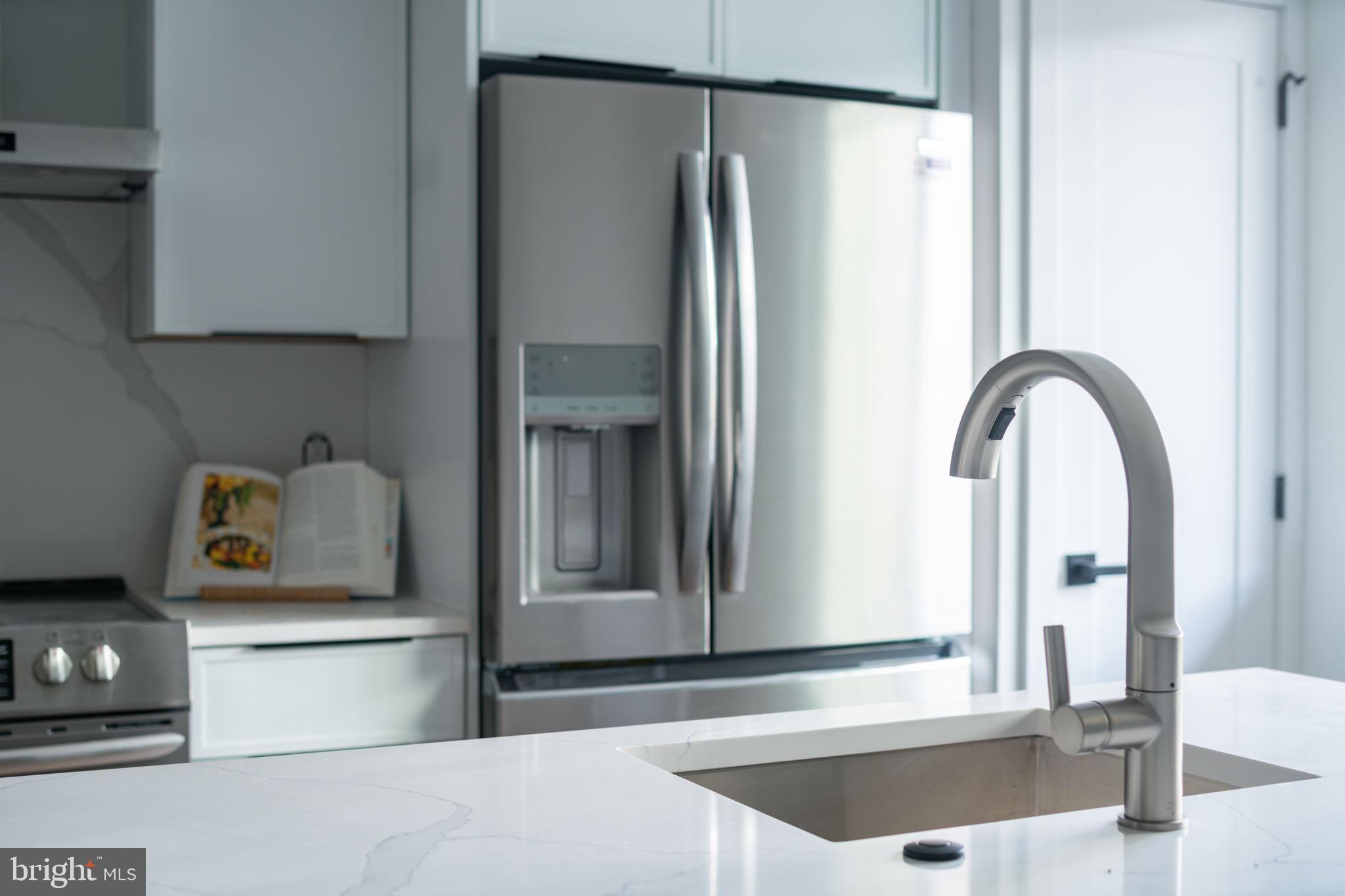 2607 East Boston Street, Unit 1 Philadelphia, PA 19125 - Photo 20 of 25 a kitchen with a refrigerator and a stove