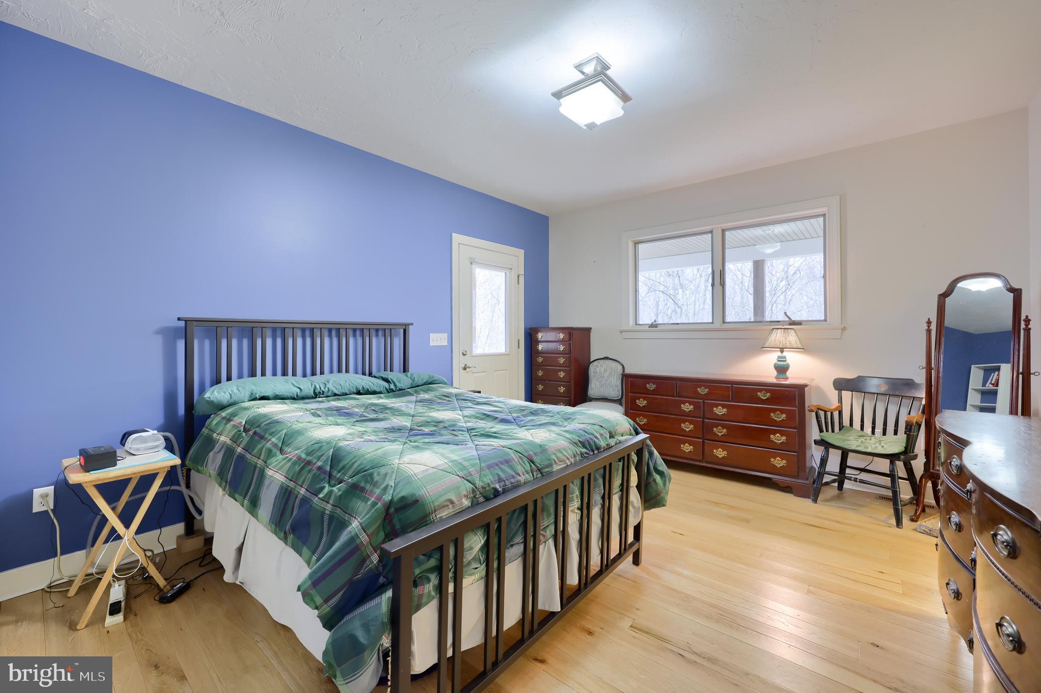 4495 Beards School Road Spring Grove, PA 17362 - Photo 19 of 57 a bedroom with a bed next to a window with pc on the table