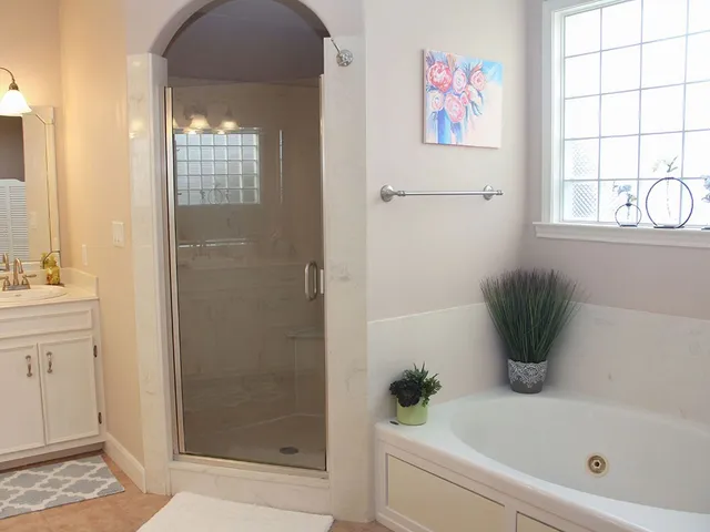 a bathroom with a bathtub and shower