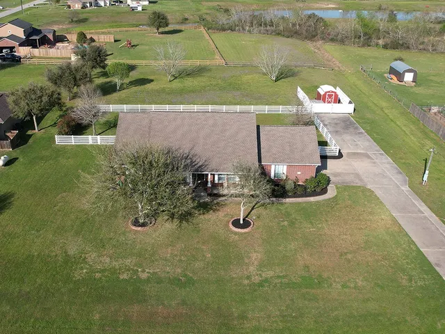 an aerial view of a house with a yard