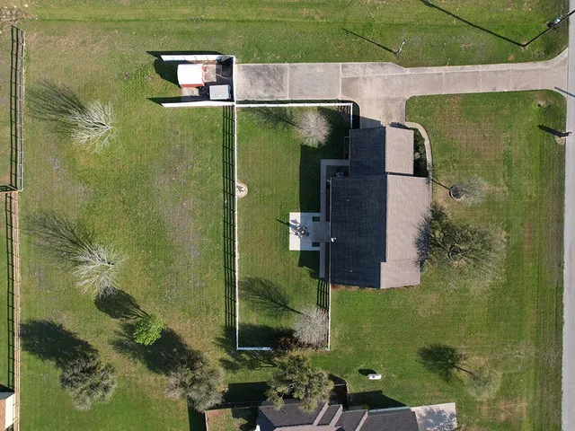 an aerial view of a house with a yard