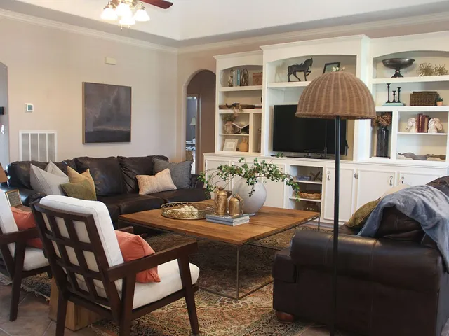 a living room with furniture a flat screen tv and a chandelier