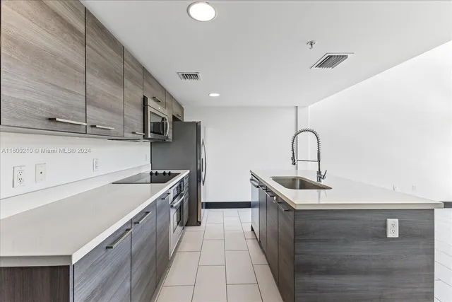 a kitchen with a sink and a large window