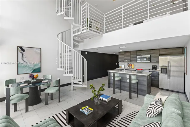 a living room with furniture kitchen view and a window