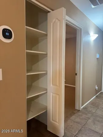 a small space with wooden floor and a window