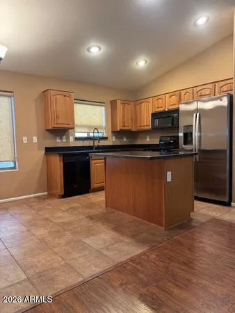 a kitchen with stainless steel appliances a stove a sink and a refrigerator