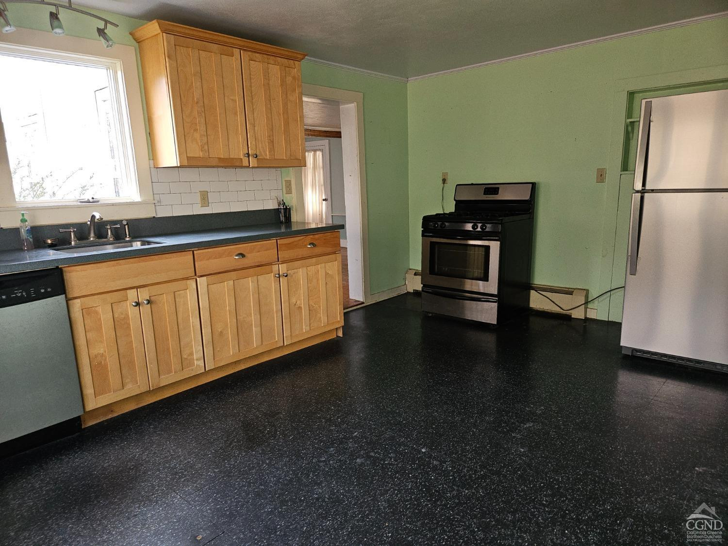 51 Dunbar Road Hudson, NY 12534 - Photo 20 of 32 a kitchen with stainless steel appliances granite countertop a refrigerator a stove a sink and a granite counter tops with wooden floors