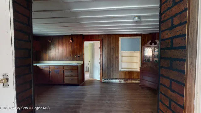 a view of kitchen with cabinets and wooden floor