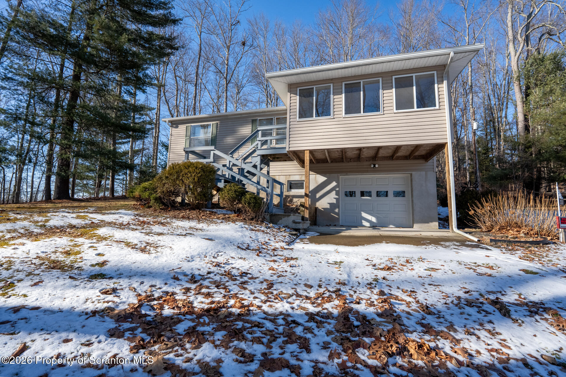 13 Hillside Drive Nicholson, PA 18446 - Photo 10 of 34 a front view of a house with a yard covered with snow