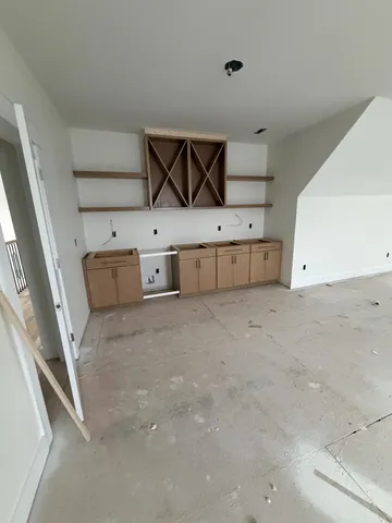 a view of a room with wooden floor