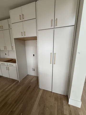 a kitchen with stainless steel appliances a stove a sink and white cabinets