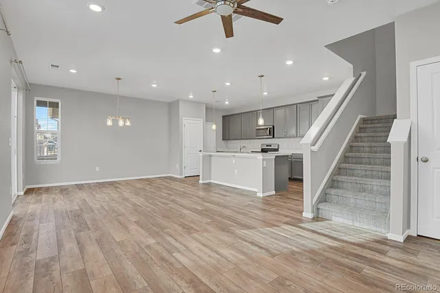 an open kitchen with kitchen island and stainless steel appliances