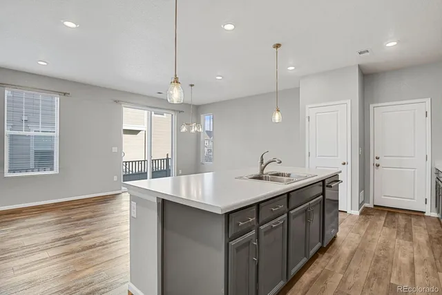 a kitchen with a sink a counter top space and stainless steel appliances