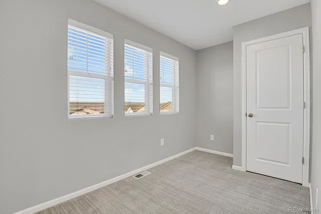 a view of hallway with wooden floor