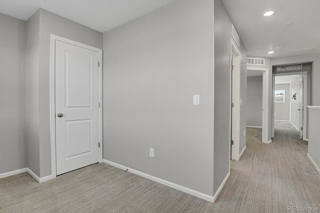 a view of hallway with wooden floor