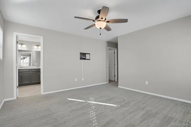 a bathroom with a toilet sink and a mirror