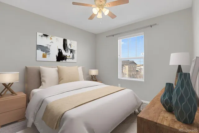 an empty room with a window and a chandelier fan