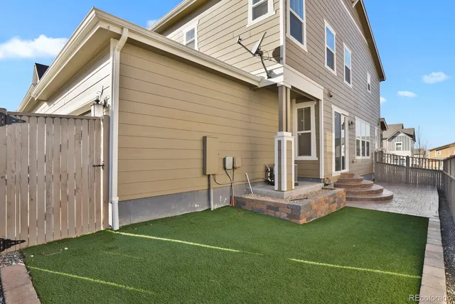 a view of a house with wooden fence
