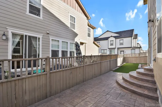 a front view of a house with a garden and plants