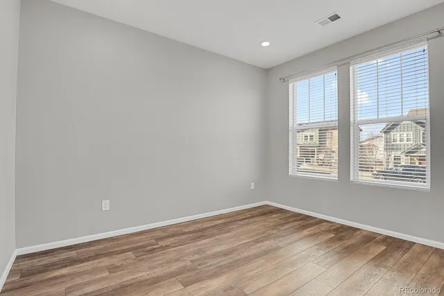 a view of an empty room and wooden floor