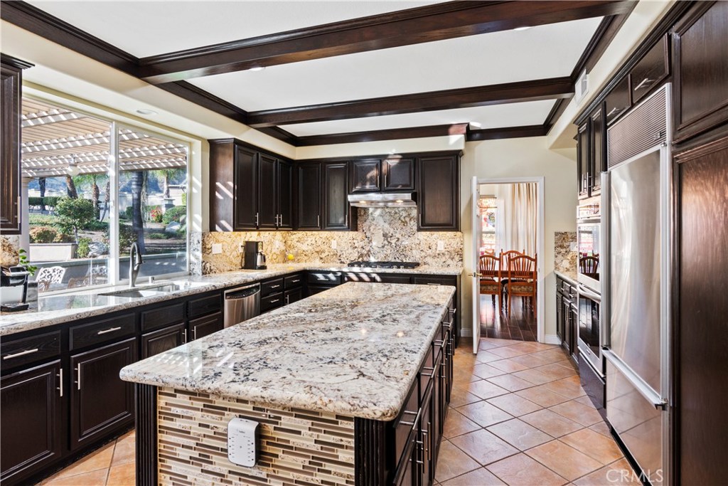 4954 Crestview Place Rancho Cucamonga, CA 91701 - Photo 18 of 40 a kitchen with a stove a refrigerator and a sink