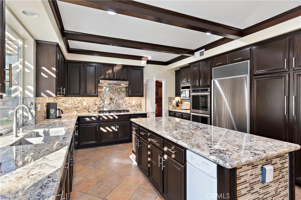 4954 Crestview Place Rancho Cucamonga, CA 91701 - Photo 19 of 40 a kitchen with stainless steel appliances granite countertop a sink stove and refrigerator