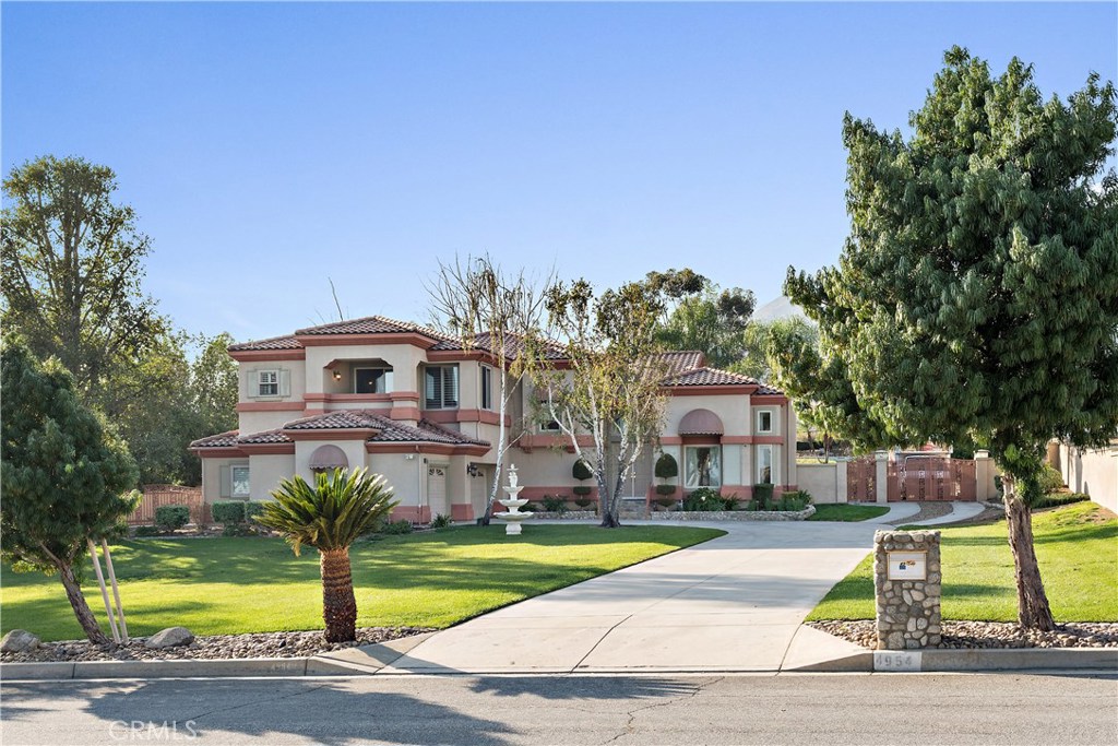 4954 Crestview Place Rancho Cucamonga, CA 91701 - Photo 2 of 40 a front view of house with yard and swimming pool