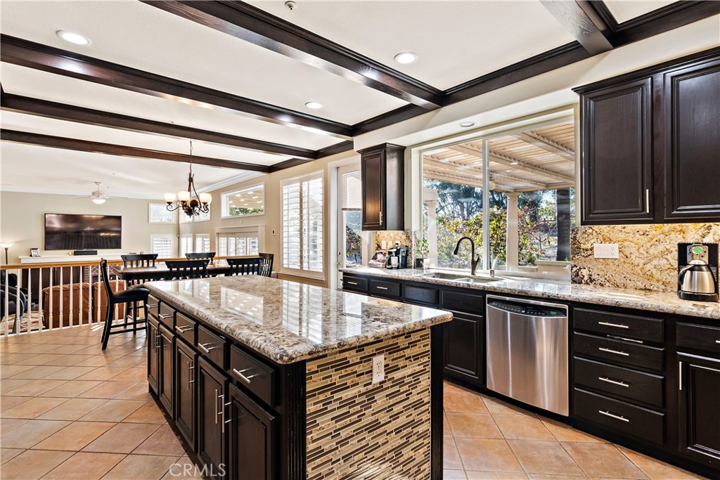4954 Crestview Place Rancho Cucamonga, CA 91701 - Photo 21 of 40 a kitchen with granite countertop a sink and wooden cabinets