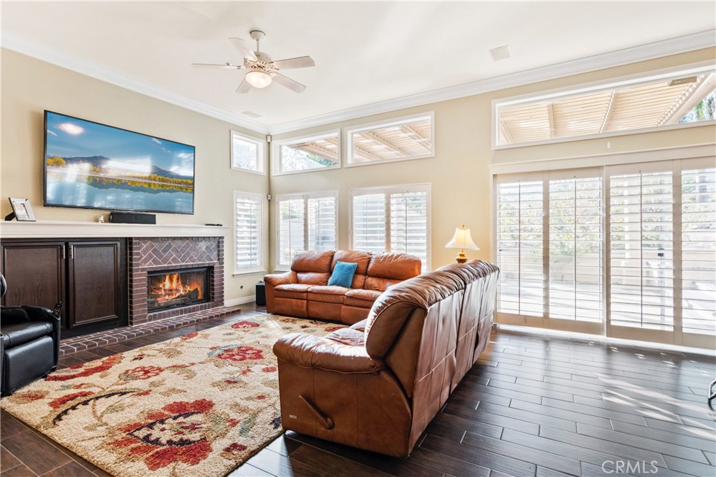 4954 Crestview Place Rancho Cucamonga, CA 91701 - Photo 28 of 40 a living room with furniture a flat screen tv and a fireplace