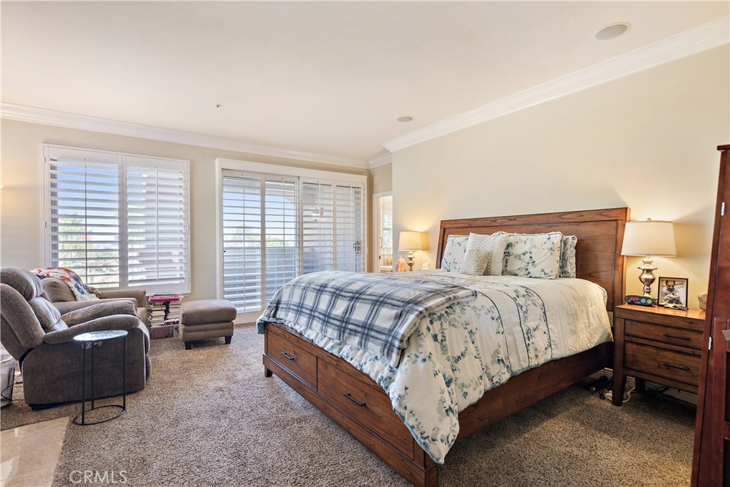 4954 Crestview Place Rancho Cucamonga, CA 91701 - Photo 30 of 40 a bedroom with a bed couches chair and a large window