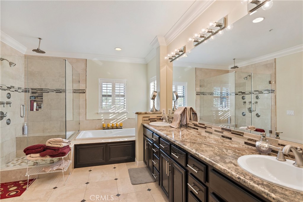 4954 Crestview Place Rancho Cucamonga, CA 91701 - Photo 31 of 40 a spacious bathroom with a granite countertop double vanity sink a mirror and a shower