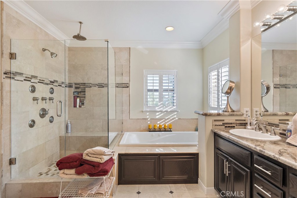 4954 Crestview Place Rancho Cucamonga, CA 91701 - Photo 32 of 40 a bathroom with a granite countertop sink a toilet and shower