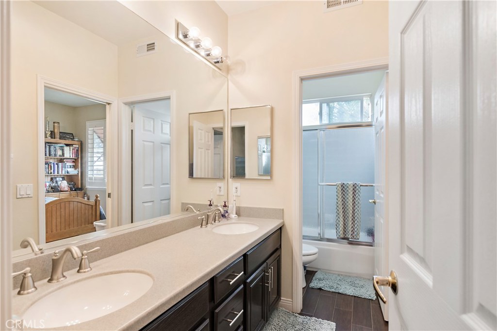 4954 Crestview Place Rancho Cucamonga, CA 91701 - Photo 35 of 40 a bathroom with a sink double vanity granite and a mirror
