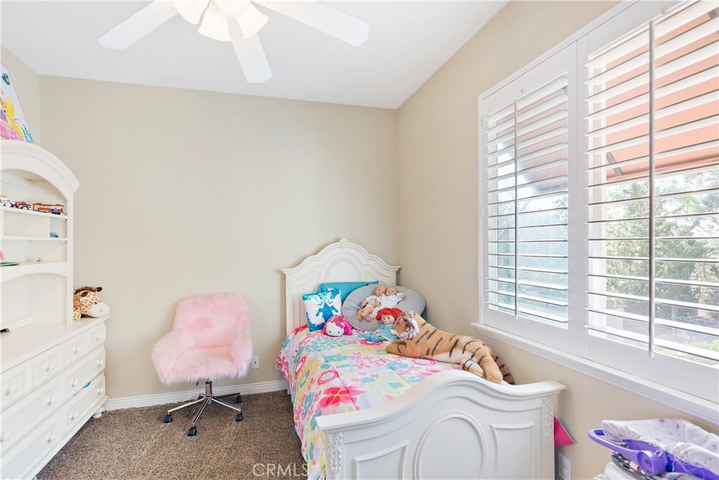 4954 Crestview Place Rancho Cucamonga, CA 91701 - Photo 37 of 40 a bedroom with a bed dresser and a window