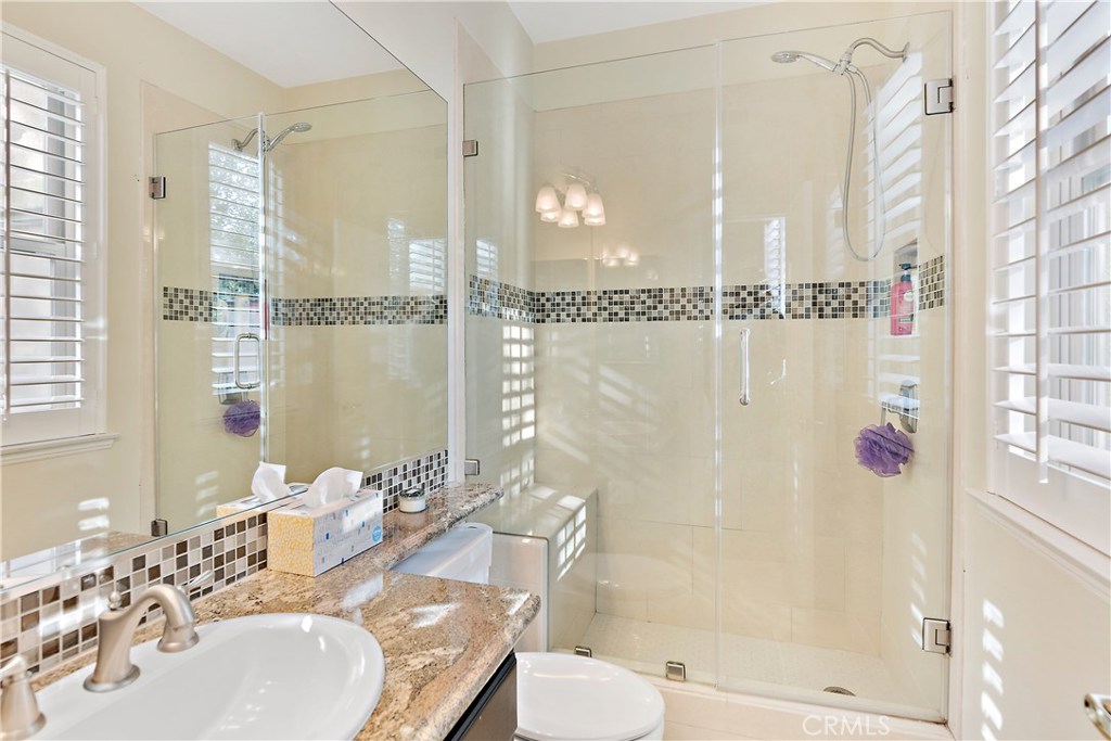 4954 Crestview Place Rancho Cucamonga, CA 91701 - Photo 40 of 40 a bathroom with a granite countertop sink a toilet and shower