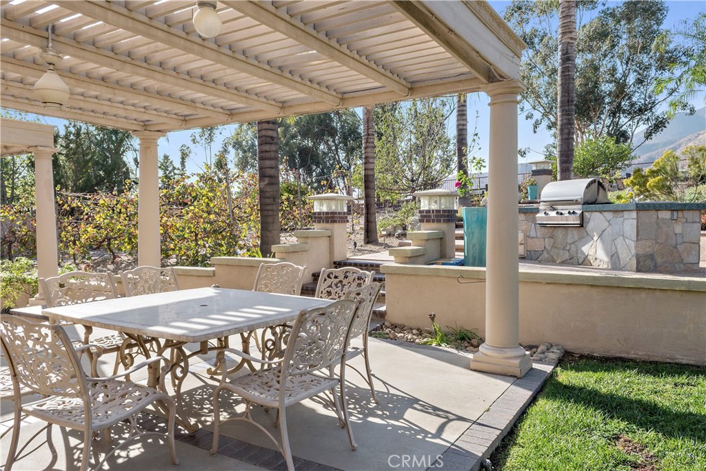 4954 Crestview Place Rancho Cucamonga, CA 91701 - Photo 9 of 40 a view of a patio with table and chairs and potted plants