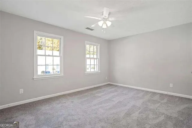 a view of an empty room with windows
