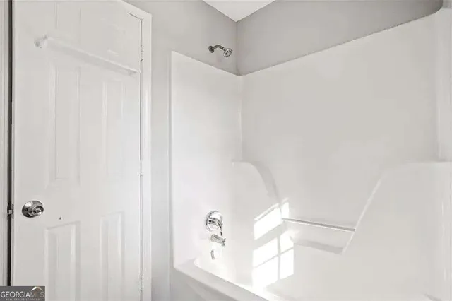 a bathroom with a bathtub and shower