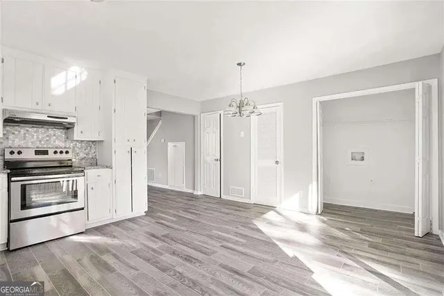 a view of a kitchen with a stove cabinets and wooden floor
