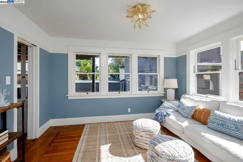 a kitchen with stainless steel appliances wooden floors wooden cabinets and dining table
