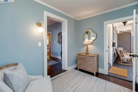 a bedroom with a bed and a couch next to a window