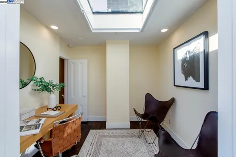 a view of a house with backyard and trees